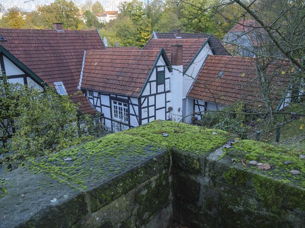 Village view with half-timbered houses, red roofs and moss-covered stones in autumn, Tecklenburg,