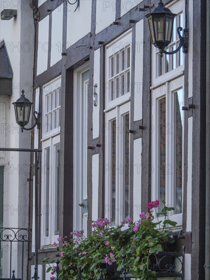 Half-timbered houses with flower boxes and lanterns on the facades, a cosy atmosphere, Tecklenburg,