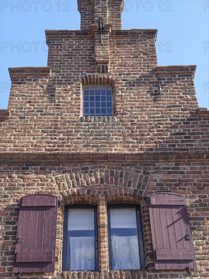 Close-up of a historic brick building with striking window sills and shutters, Doesburg,