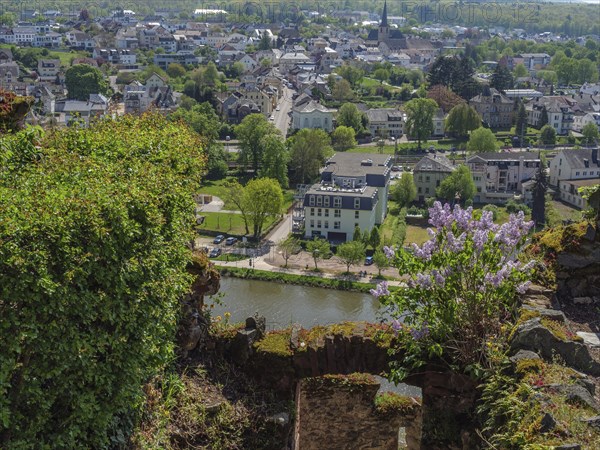 View from a hill on a town with a river, many buildings and green trees, Saarburg, germany