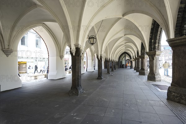 Arcades under the townhall of Luebeck, Germany, historic architecture at the market place in the
