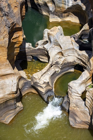 Eroded rock formations, canyon with steep orange-coloured rock cliffs with the Blyde River,