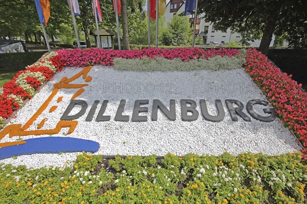 Colourful flower bed with flags, floral decoration and inscription, Dillenburg, Hesse, Germany,