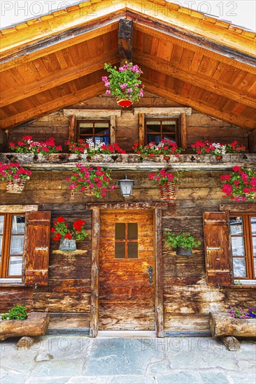 Old wooden house with floral decorations, historic village centre, Grimentz, Val d'Anniviers,