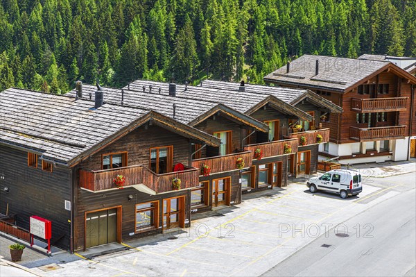 Parked car in front of wooden terraced houses, historic village centre, Grimentz, Val d'Anniviers,