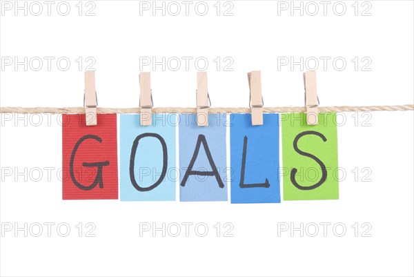 Goals, Colorful words hang on rope by wooden peg