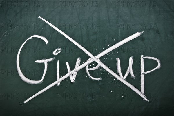 Do not give up, words on blackboard