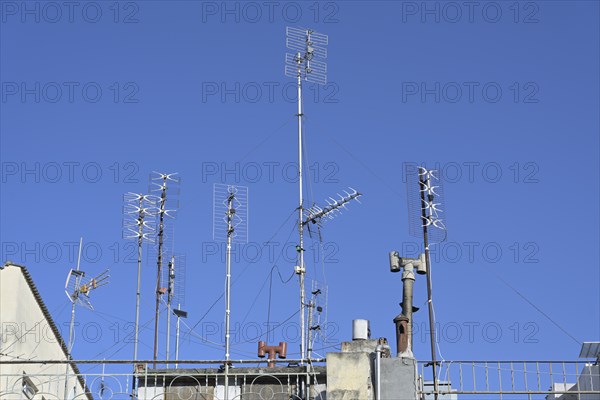 Various antennas on the roof of a residential apartment building, installation for communication