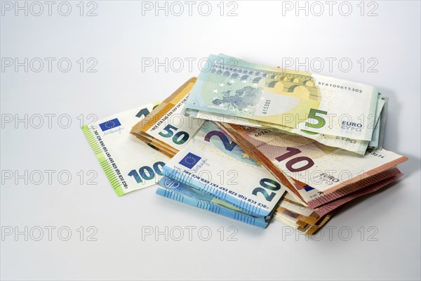 Stack of different euro banknotes on a light gray background, concept for business, finance,