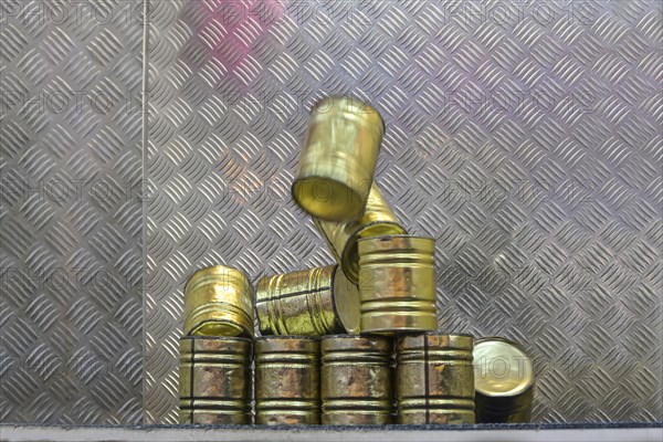 Falling tin can pyramid hit by a ball, throwing game at a carnival funfair or Christmas market,