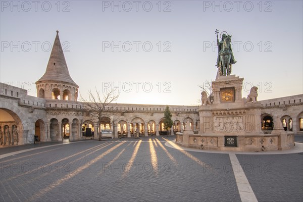Old historic fortress and church at sunrise. City panorama at dusk. View of the Danube Fishermen's