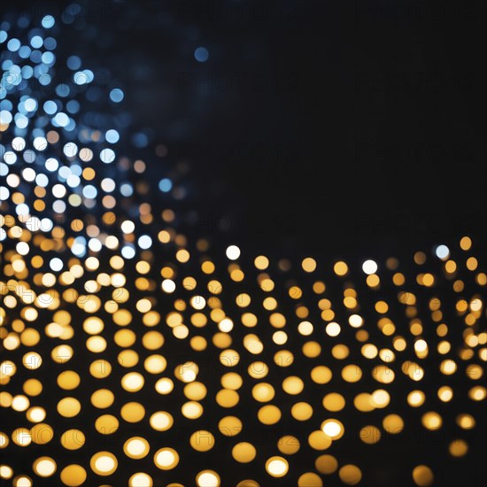 Abstract bokeh effect combining warm-colored and blue lights creating a glowing and patterned