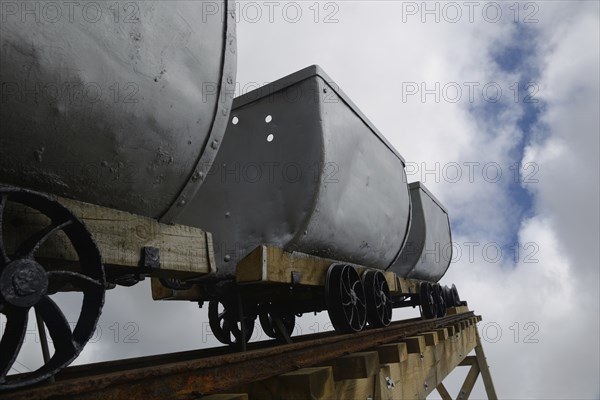 A coal mining memorial at Dobson in New Zealand features vintage coal wagons from an underground