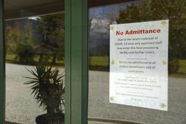 Signage shows that an essential food processing business has restricted access during the Covid 19