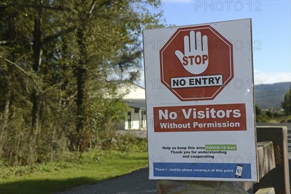 Signage shows that an essential business has restricted access during the Covid 19 lockdown in New