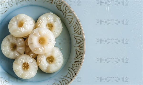 Korean steamed rice cakes (tteok) on a light blue background AI generated