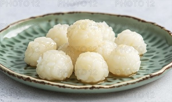Korean honey rice cakes (yakgwa) on a pastel green plate AI generated