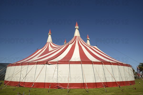 Colourful circus tent against a blue sky