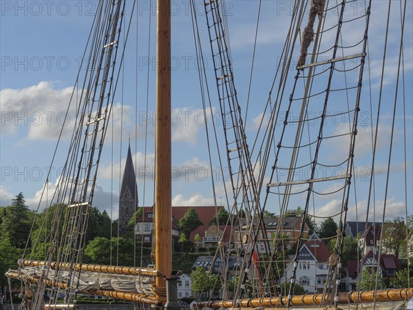 Detail of a sailing mast with a view of a church and houses in the background, Eckernförde,