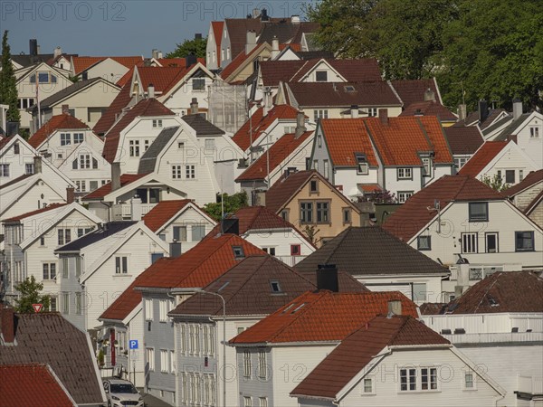 A neighbourhood with numerous houses and red tiled roofs, built close together, Stavanger, Norway,