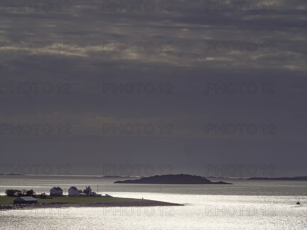 Twilight over a tranquil coastal landscape with silhouetted islands, Stavanger, Norway, Europe