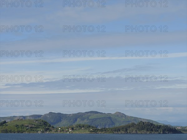 Coastal landscape with a view of the sea and wooded hills in the background, Stavanger, Norway,