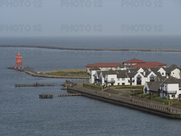 Coastal town with white houses, lighthouse and promenade, view of the blue sea, Newcastle, England,