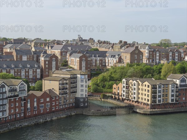 Residential building along a river with a view of the city, Newcastle, England, Great Britain