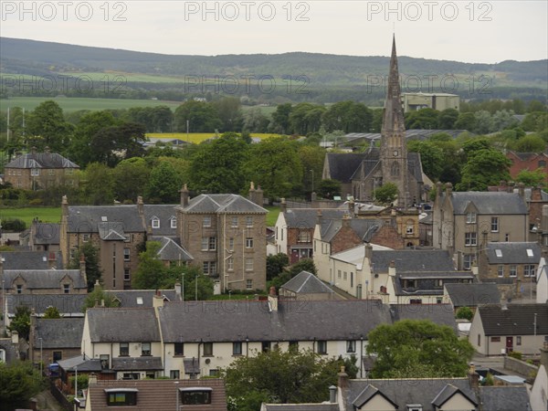A village with a church and houses surrounded by green countryside and hills, inverness, Scotland,