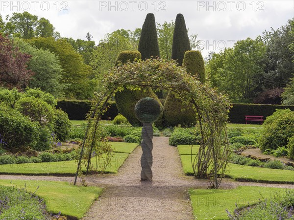 Well-kept garden with lawns, shrubs and a sculpture in the centre, inverness, Scotland, United