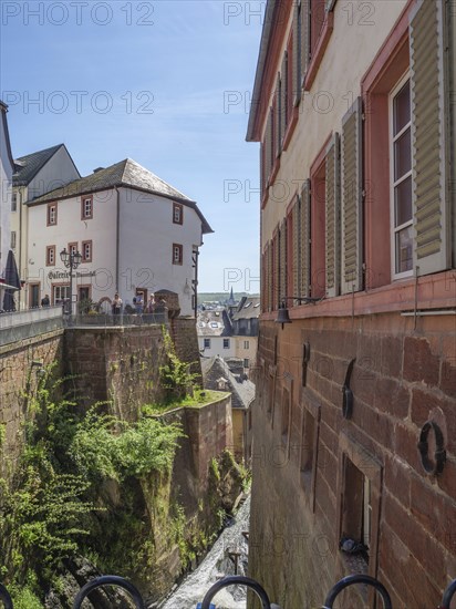 Historic buildings in a narrow alley of the old town, stone facades visible, Saarburg, Germany,