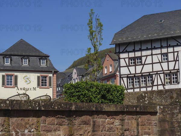 Historic buildings, including a museum and a half-timbered house, in sunny weather, Saarburg,