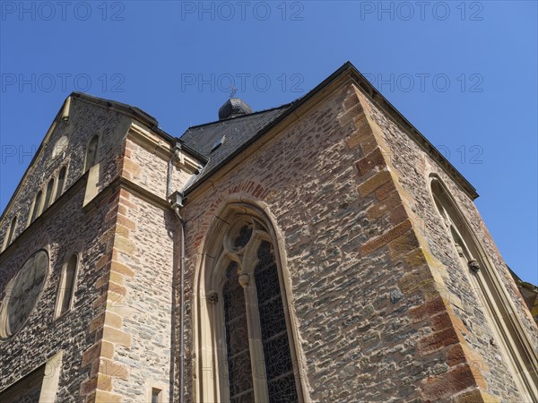 Gothic brick church under a blue sky, close-up of spire and window, Saarburg, Germany, Europe