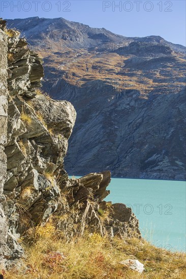 Turquoise lake in the middle of a rocky mountain landscape in autumn, Saas Fee, Switzerland, Europe
