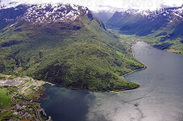 Breathtaking panorama of a fjord with snow-capped mountains and dense forests, view from Hoven,
