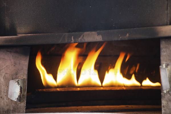 The yellow flames in a stone oven in display