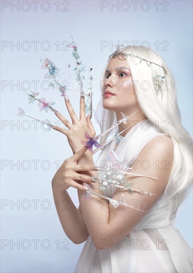 Beautiful woman with art make-up, creative long nails. Design manicure. Beauty face. Picture taken