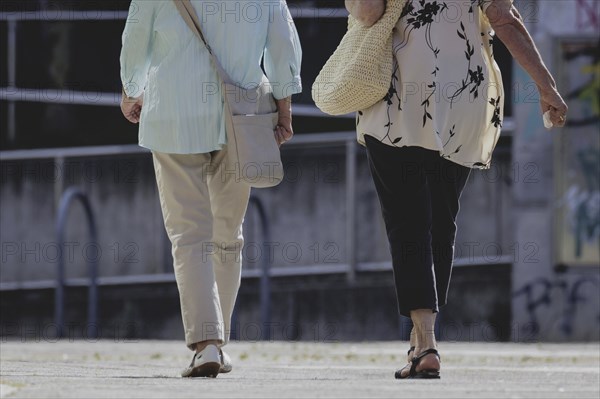 Two older woman walking together, taken in Berlin, 07/08/2024
