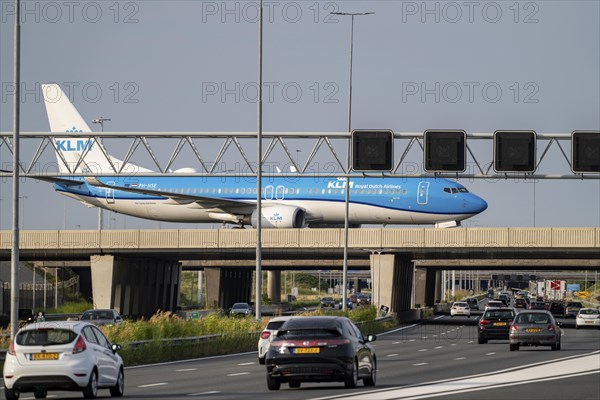Amsterdam Schiphol Airport, KLM Boeing 737 aircraft on the taxiway, bridge over the A4 motorway,