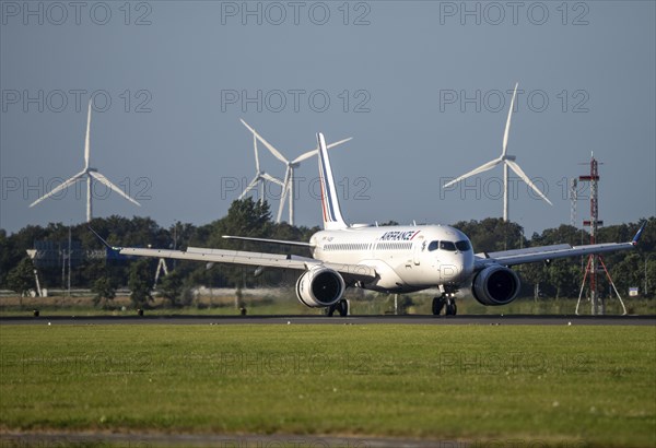 Air France aircraft landing at Amsterdam Schiphol Airport, Polderbaan, 18R/36L, wind farm in the