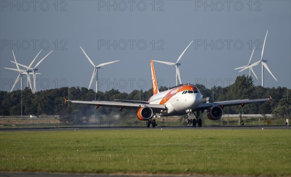 Easyjet aircraft landing at Amsterdam Schiphol Airport, Polderbaan, 18R/36L, wind farm in the