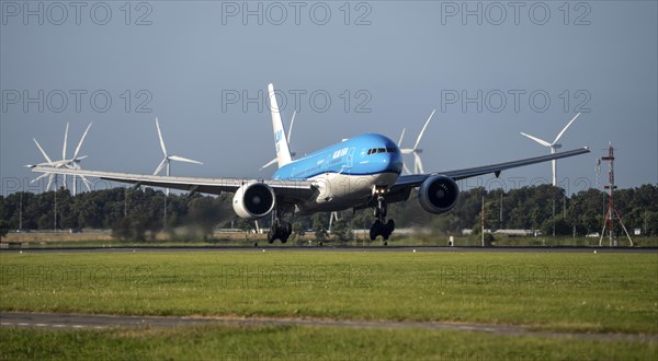 KLM aircraft landing at Amsterdam Schiphol Airport, Polderbaan, 18R/36L, wind farm in the