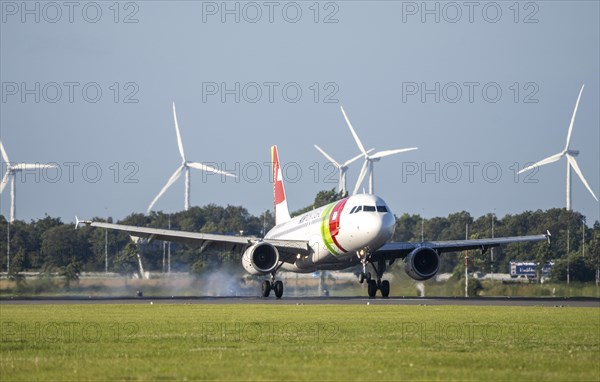 AirPortugal, aircraft landing at Amsterdam Schiphol Airport, Polderbaan, 18R/36L, wind farm in the