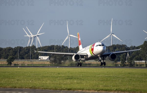 AirPortugal, aircraft landing at Amsterdam Schiphol Airport, Polderbaan, 18R/36L, wind farm in the