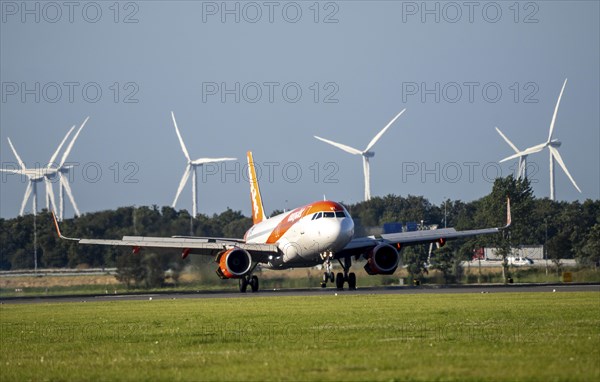 EasyJet, aircraft landing at Amsterdam Schiphol Airport, Polderbaan, 18R/36L, wind farm in the