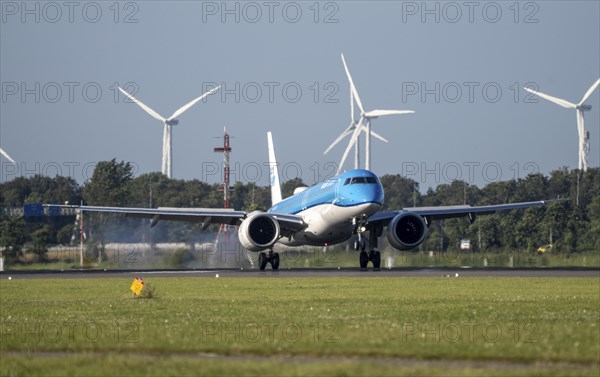 KLM aircraft landing at Amsterdam Schiphol Airport, Polderbaan, 18R/36L, wind farm in the