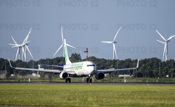 Transavia aircraft landing at Amsterdam Schiphol Airport, Polderbaan, 18R/36L, wind farm in the