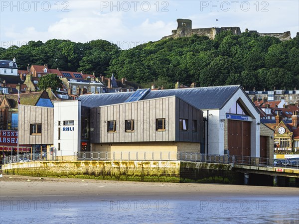 RNLI Scarborough Lifeboat Station and boat over Scarborough Beach, Scarborough, North Yorkshire,