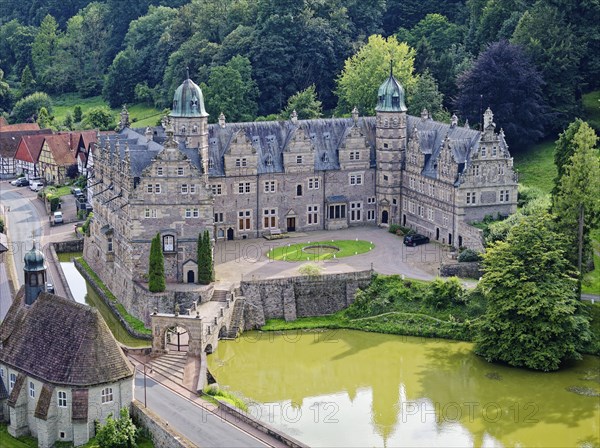 Aerial view of Hämelschenburg Castle, built in the Weser Renaissance style, with gardens, pond and