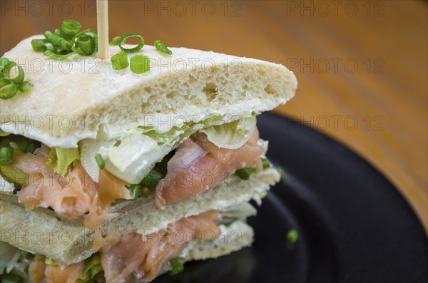 Delicious salmon sandwich close-up and glass of beer